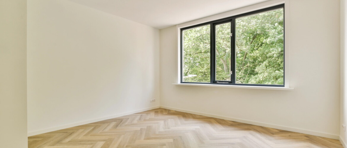 wooden herringbone flooring in white room